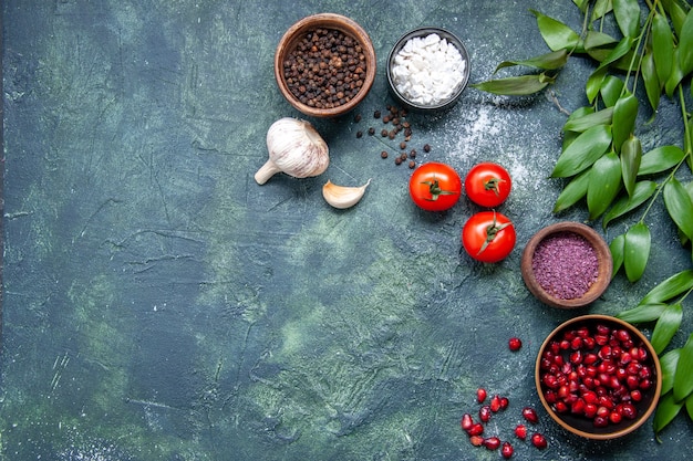 Top view fresh red tomatoes with garlic and seasonings on dark background color ripe salad meal photo health diet