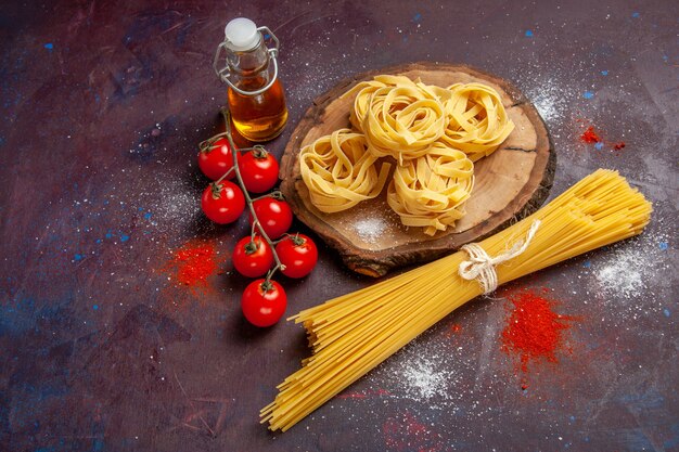 Top view fresh red tomatoes with raw pasta on dark background raw salad pasta food meal