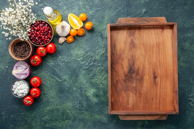 Top view fresh red tomatoes with wooden desk on a dark-blue background health meal salad food color photo diet free space