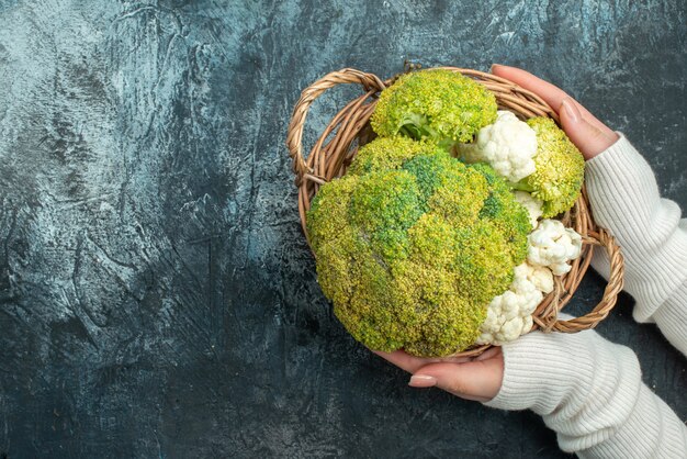 Top view fresh ripe cauliflower inside basket on light-grey table