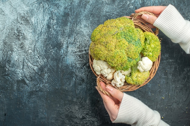 Top view fresh ripe cauliflower inside basket on light-grey table