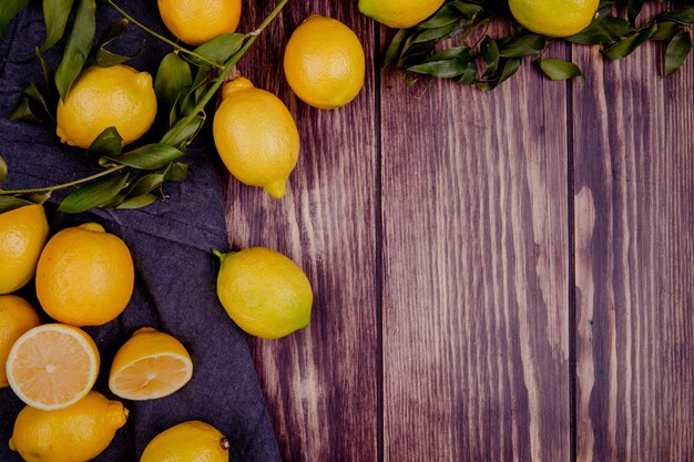 Top view of fresh ripe lemons isolated on rustic with copy space