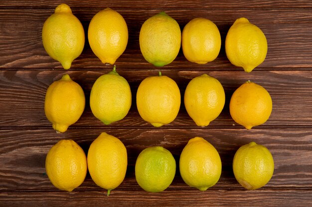 Top view of fresh ripe lemons isolated on rustic wood