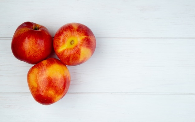 Top view of fresh ripe nectarines isolated on white with copy space