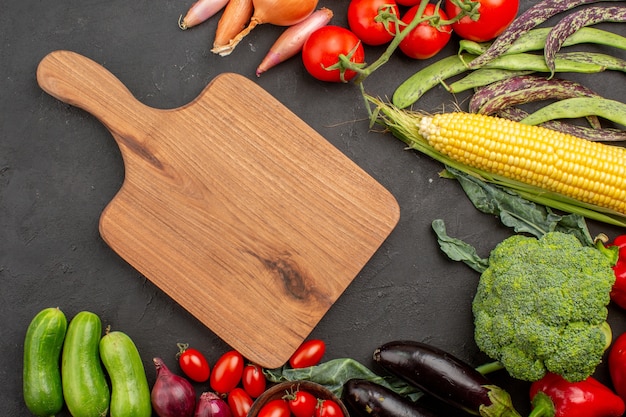 Top view fresh ripe vegetables composition on grey desk