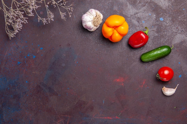 Top view fresh ripe vegetables on a dark surface salad health meal vegetable