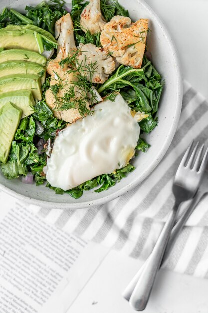 Top view of the fresh salad with a fried egg