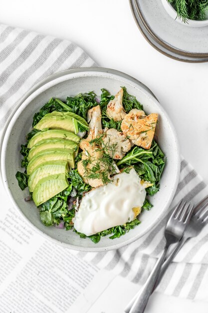 Top view of the fresh salad with a fried egg