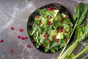 Free photo top view fresh salad with pomegranate seeds