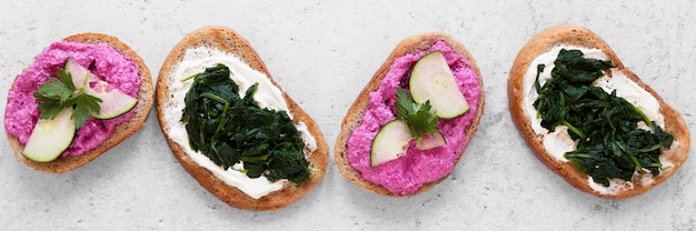 Top view fresh sandwiches arrangement on cement background