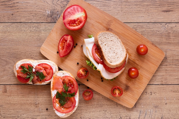 Top view fresh sandwiches composition on wooden background