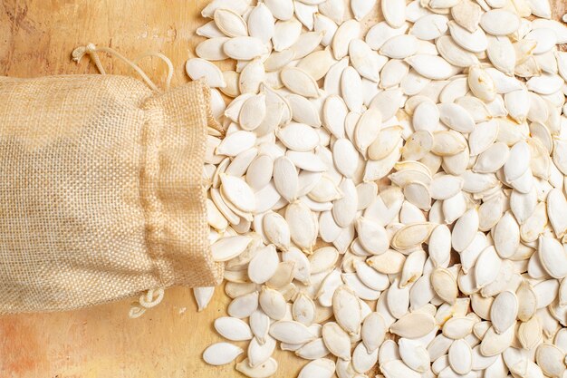 Top view of fresh seeds lined on a wooden desk