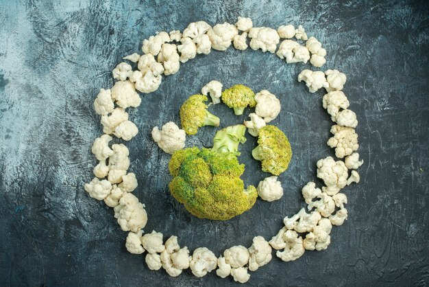 Top view fresh sliced cauliflower lined in circle on light-grey table