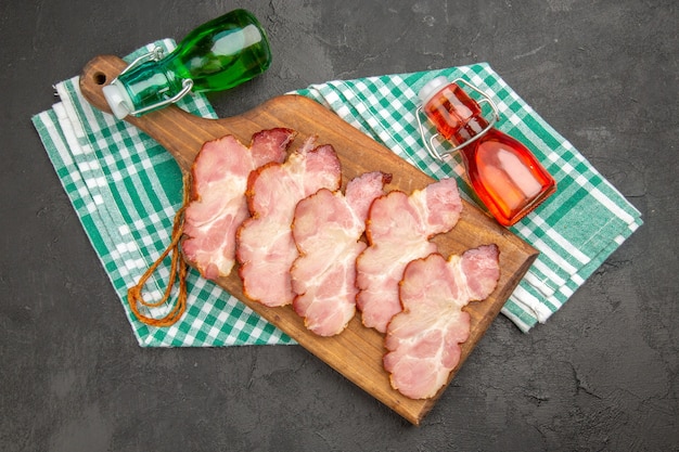 Top view fresh sliced ham on grey background