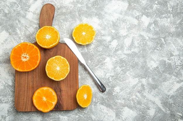 Top view fresh sliced oranges mellow citruses on white surface ripe fruits exotic fresh tropical