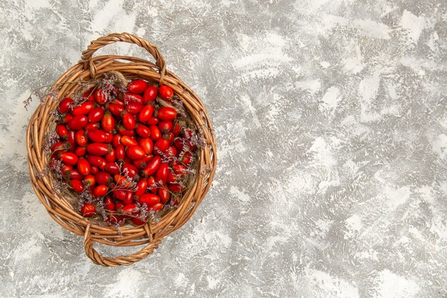 Top view fresh sour dogwoods inside basket on white background fruits berry vitamine sour mellow plant tree wild