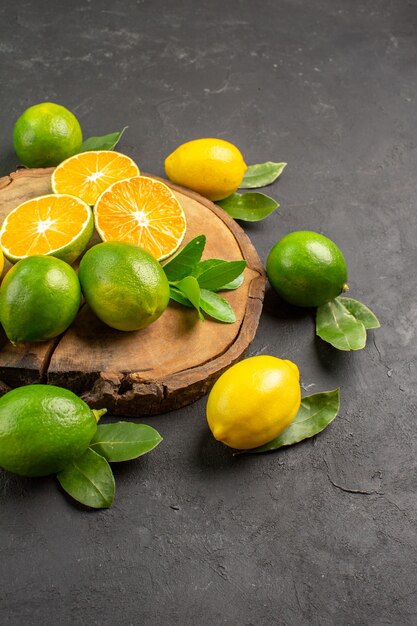 Top view fresh sour lemons on dark floor citrus lime fruit