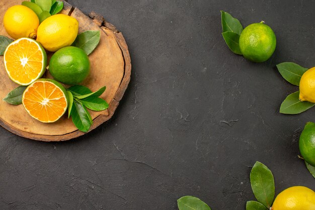 Top view fresh sour lemons on dark-grey table fruit citrus lime