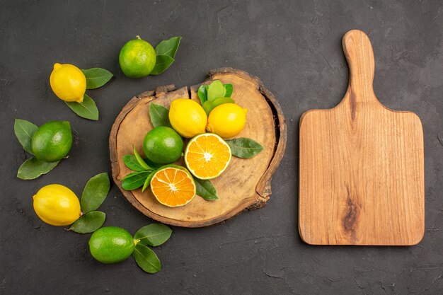 Top view fresh sour lemons on a dark table fruit citrus lime