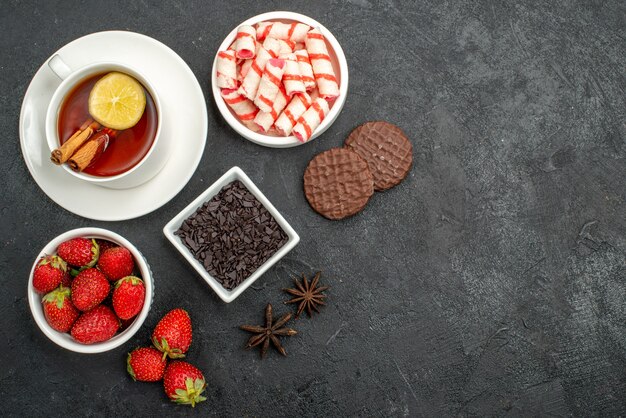 Top view fresh strawberries with sweets and tea