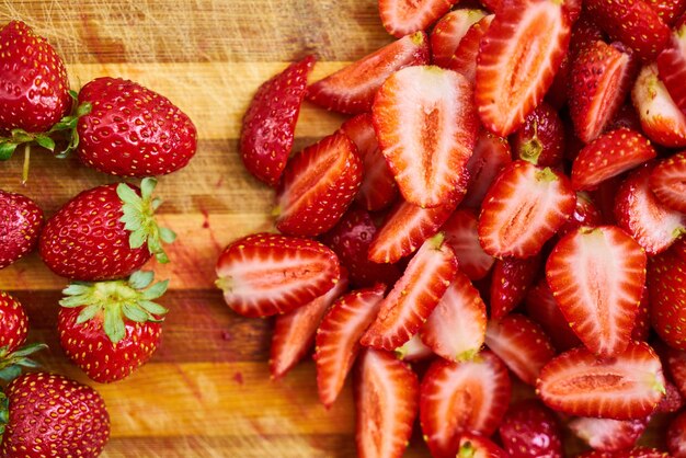 Top view of the fresh strawberries on the wooden board on a table