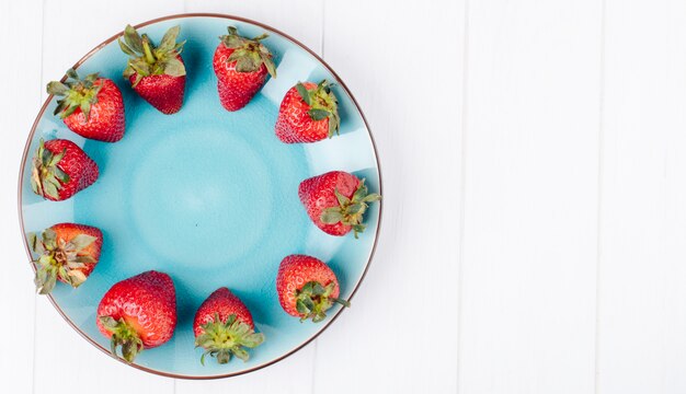 Top view fresh strawberry on the left with copy space on white background