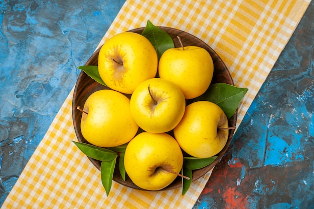 Top view fresh sweet apples inside plate on blue background