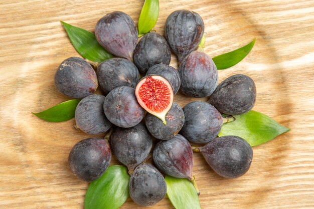 Top view fresh sweet figs inside plate on dark