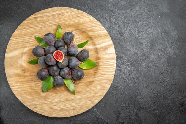 Top view fresh sweet figs inside plate on grey background