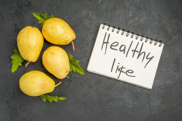 Top view fresh sweet pears on grey background