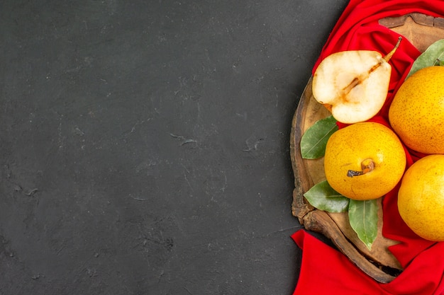 Top view fresh sweet pears on red tissue and dark table ripe fresh color mellow