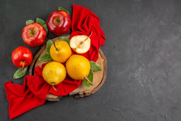 Top view fresh sweet pears with apples on the dark table fresh mellow color ripe