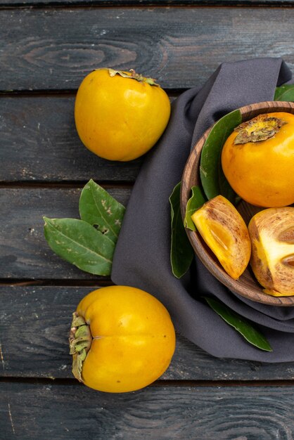 Top view fresh sweet persimmons on wooden floor ripe fruit mellow