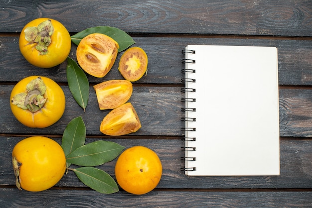 Top view fresh sweet persimmons on wooden rustic table, fruit ripe mellow