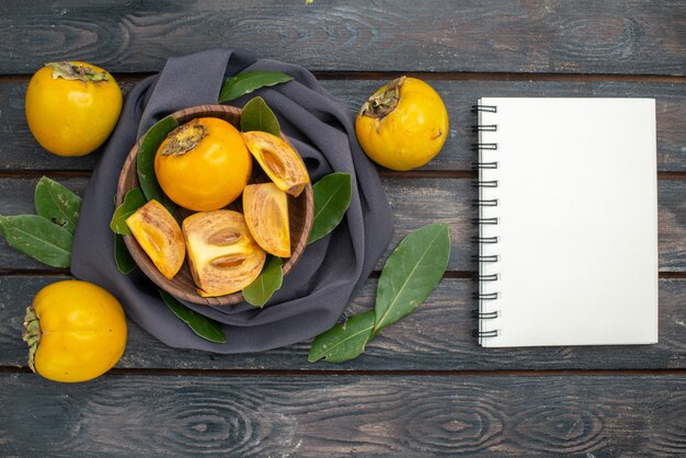 Top view fresh sweet persimmons on wooden table, fruit ripe mellow