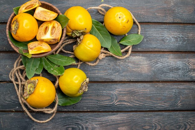 Top view fresh sweet persimmons on a wooden table, fruit ripe taste