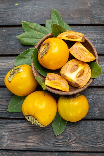 Top view fresh sweet persimmons on wooden table, fruit ripe taste