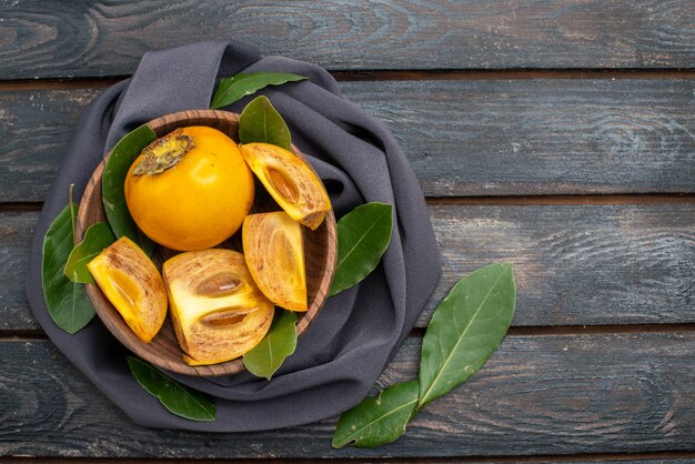 Top view fresh sweet persimmons on a wooden table, mellow fruit health