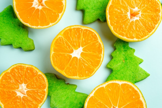 Top view fresh tangerine slices on light-blue background