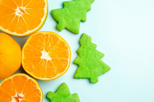 Top view fresh tangerine slices on the light-blue background