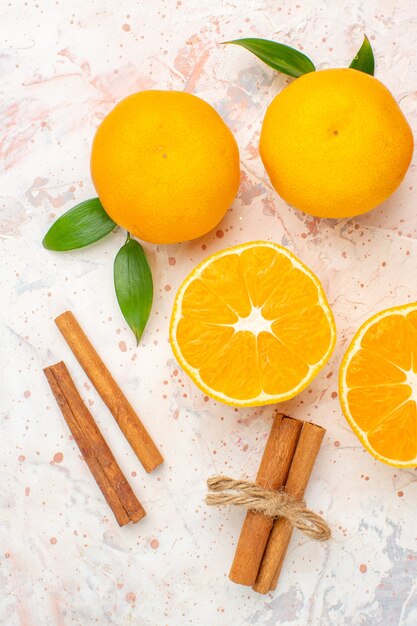 Top view fresh tangerines cinnamon sticks on bright surface