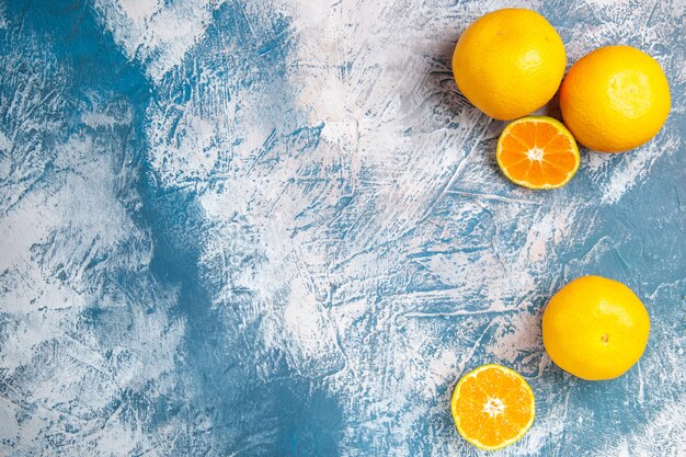 Top view fresh tangerines on light-blue background