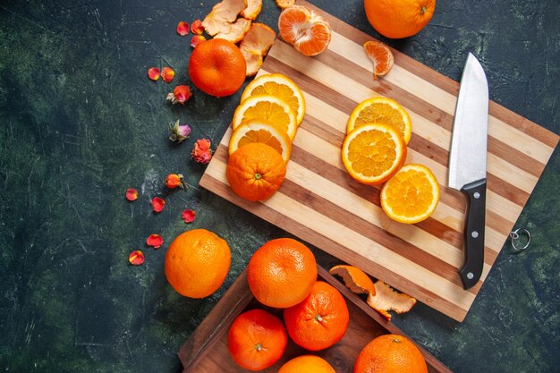 Top view fresh tangerines with oranges on dark background vegetable diet salad drink food citrus fruit meal health exotic