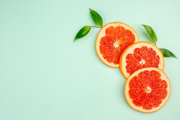 Top view fresh tasty grapefruits on light-blue background