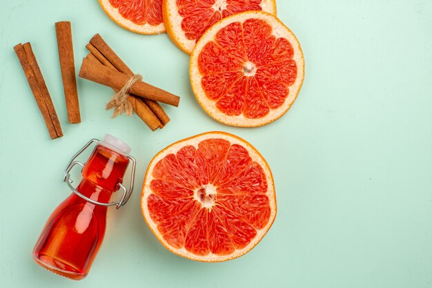 Top view fresh tasty grapefruits with cinnamon on the light-blue background