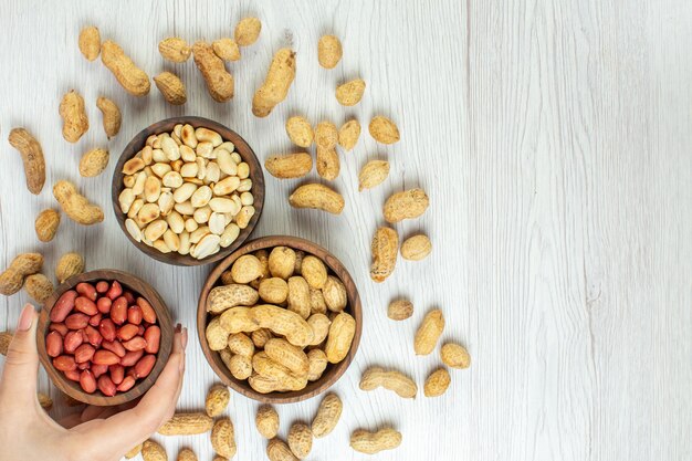 top view fresh tasty peanuts on white table color nut cinema photo snack movies seed