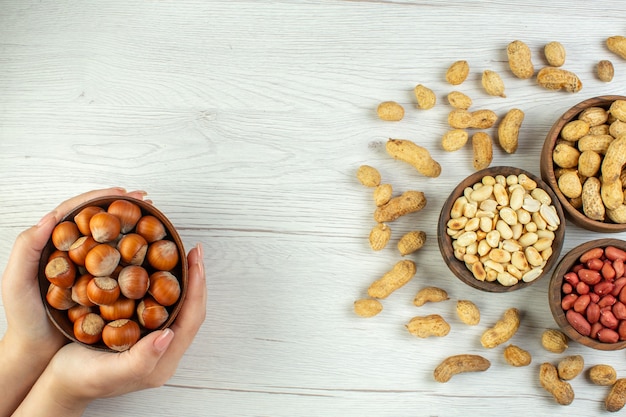 Top view fresh tasty peanuts on white table