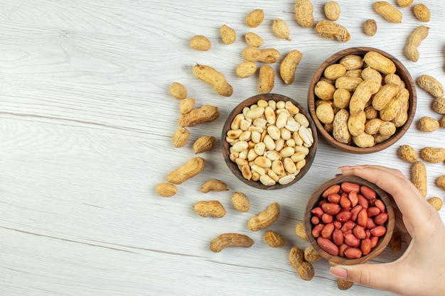 Top view fresh tasty peanuts on white table