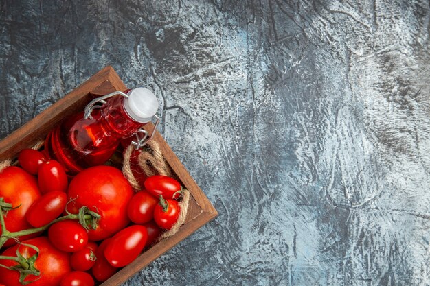 Top view fresh tomatoes with cherry ones inside box