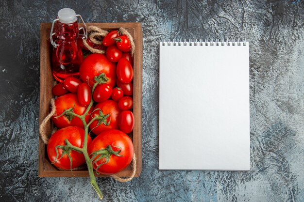 Top view fresh tomatoes with cherry ones inside box